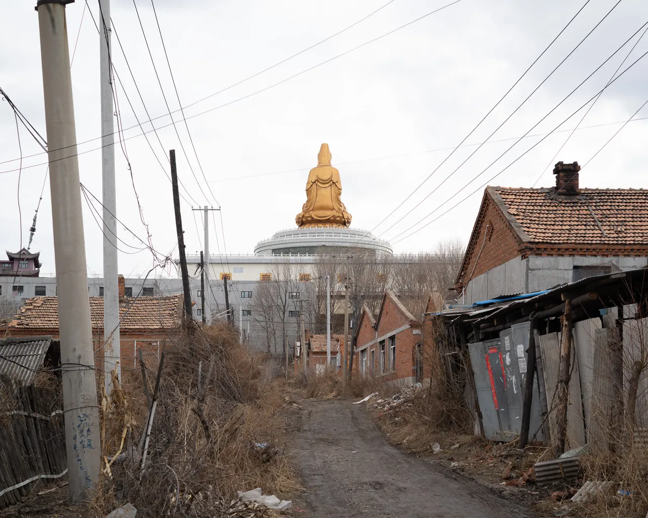 An alley and a Buddha statue.